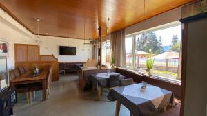 a restaurant with tables and chairs and a large window at Vermietung DANIS in Liezen