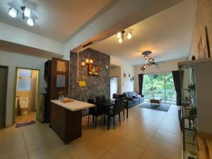 a kitchen and living room with a table and chairs at Cameron Forest Home - Golden Hills in Cameron Highlands