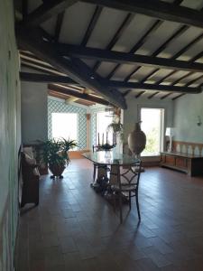 uma sala de jantar com uma mesa e uma sala com janelas em Casa Arezzola em Spoleto