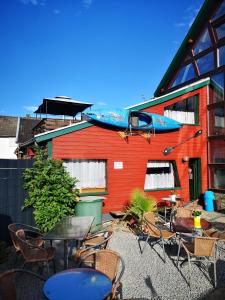 a building with tables and chairs and a boat on top of it at Ferienhof Schmickerath in Simmerath