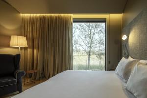 a hotel room with a bed and a window at Monverde - Wine Experience Hotel - by Unlock Hotels in Amarante
