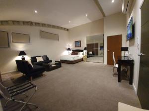 a large living room with a bed and a couch at Hangar House Mudgee in Mudgee