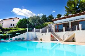 a swimming pool in front of a villa at Residence Chiesiola in Vieste