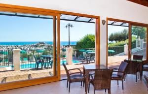a patio with a table and chairs and a view of the ocean at Residence Chiesiola in Vieste