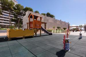 a playground with a slide and a play structure at Apartamentos Nuevo México C 432 in Calpe