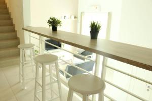 a kitchen with a counter and stools in a room at NEW SEAVIEW Cozy Modern Beach House in Tanjung Bungah