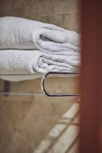 a stack of white towels on a towel rack at Silken Coliseum in Santander