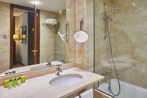 a bathroom with a sink and a shower at Silken Coliseum in Santander