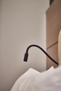 a black lamp sitting on top of a bed at Silken Coliseum in Santander
