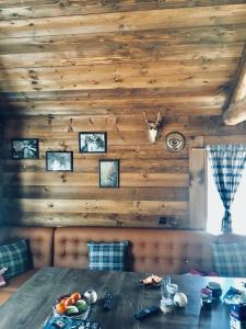 a dining room with a table and a wooden wall at Къща за гости Виевци in Vievo +15 photos