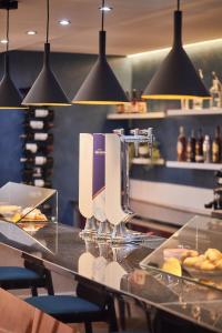 a counter in a restaurant with a bar with food at Silken Coliseum in Santander