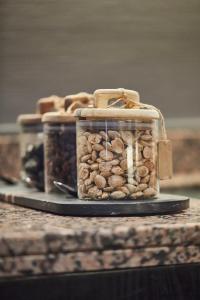 three jars filled with nuts sitting on a counter at Silken Coliseum in Santander