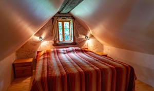 a small bedroom with a bed in a attic at Sihi Country House in Hiievälja