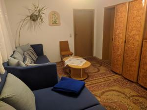 a living room with two blue couches and a table at Ferienhaus Johanna in Weischlitz