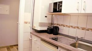 a kitchen with a sink and a counter top at Aceto Home in Berlin