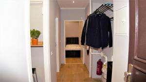 a hallway leading to a bedroom with a room with a bed at Aceto Home in Berlin