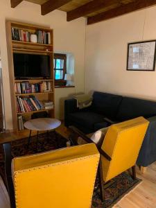 a living room with a blue couch and a yellow chair at Holiday Home Luka 10 in Kalnik