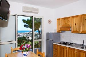a kitchen with a table and a view of the ocean at Residence Chiesiola in Vieste