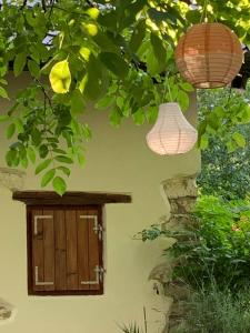 two lights hanging from a building with a window at Holiday Home Luka 10 in Kalnik