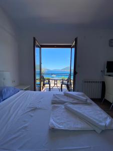 a bedroom with a bed with a view of the ocean at Apartments Family in Tivat