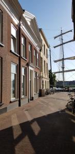 a street with buildings and a large tower in the distance at Bij Isa & Max in Kampen