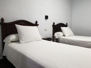 Posteľ alebo postele v izbe v ubytovaní Hostal Cuzco