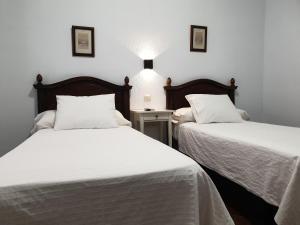 Posteľ alebo postele v izbe v ubytovaní Hostal Cuzco
