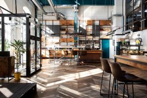 a restaurant with a bar with chairs and tables at Hektor Container Hotel in Tallinn