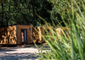 a small building with a door in a park at Les Voiles de Laives in Laives