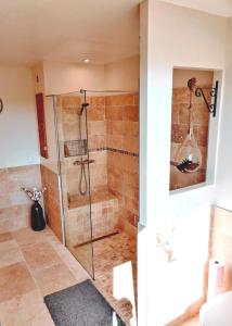 a bathroom with a shower with a glass door at Maison 190m2 - Entre Paris et Disneyland in Gagny