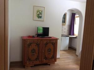 a room with a wooden cabinet with a television on it at Haus Wildspitz in Neustift im Stubaital