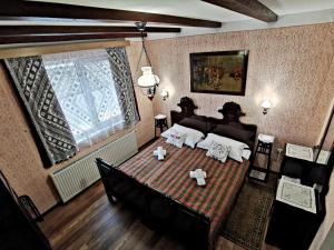 a bedroom with a large bed in a room at Apartment Slavonska Kuća in Pleternica