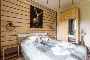 ザコパネにあるApartamenty Deja Vu Zakopaneのベッドルーム1室(鹿の絵が描かれたベッド1台付)