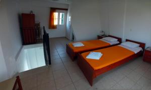 A bed or beds in a room at Iriana Village Inn