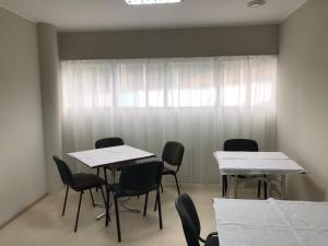 a room with two tables and chairs and a window at ГотельОК Видубичі in Kyiv