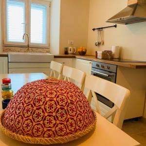 a kitchen with a table with a bowl on it at La Casetta di Gloria in Lumbarda +29 photos