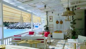 a room with tables and chairs and a view of the city at Bloom Villa By the sea in Agia Pelagia
