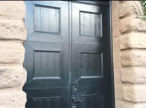 a black door with two windows on a building at Montrose Watertower in Montrose