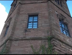 einen hohen Backsteinturm mit Fenstern auf einem Gebäude in der Unterkunft Montrose Watertower in Montrose