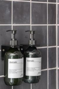 two bottles of soap sitting on a bathroom counter at Casa Boma Lisboa - Duplex Apartment In The Heart Of Lisbon - Arroios I in Lisbon