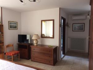 a living room with a television and a wooden dresser at Gianpaolo ospitale in Scorrano