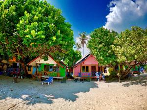 a group of houses on the beach with chairs and trees at DAYA Beach, Lipe local in Ko Lipe