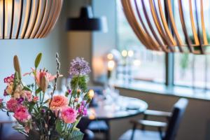 a vase of flowers sitting on top of a table at LUDIEK eten en slapen in Havelte +53 photos