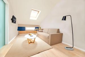 a living room with a couch and a table at Ribarska Koliba Resort in Pula