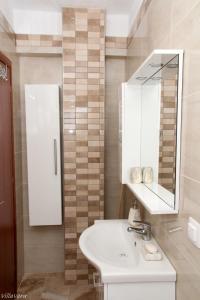 a bathroom with a sink and a mirror at Luxury Apartment in Nikiti