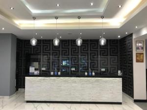 a lobby with a counter with pendant lights at Best Western Plus Meridian Hotel in Nairobi