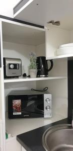 a kitchen with a microwave and a counter top at Belvárosi Apartman 3 in Miskolc