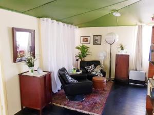 a living room with a black chair and a table at UNIQUE 1920's Historic Retreat! Pet Friendly! in Springwood