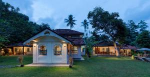 a house with a lawn in front of it at STUTHI VILLA in Ahangama