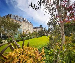 a view of a building and a garden with flowers at Hotel de France in Saint Helier Jersey